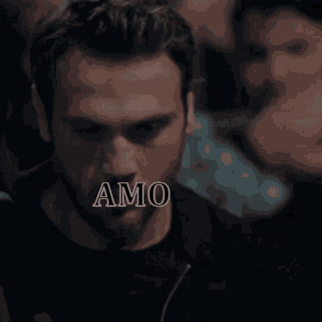 a close up of a man 's face with the word amo above it