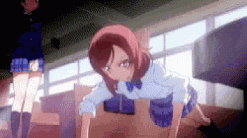 a girl in a school uniform is doing push ups on the floor in a room .