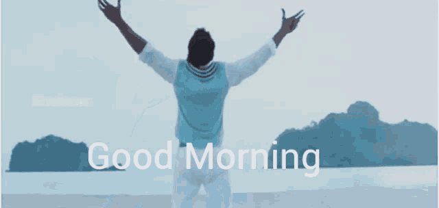 a man wearing sunglasses stands in front of a body of water with the words " good morning " below him