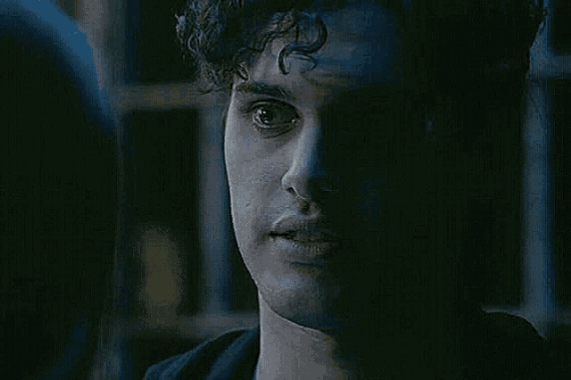 a close up of a man 's face in the dark