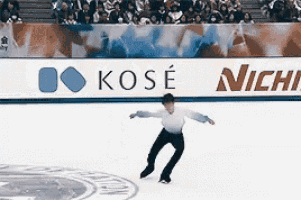 a man is ice skating in front of an advertisement for kosé