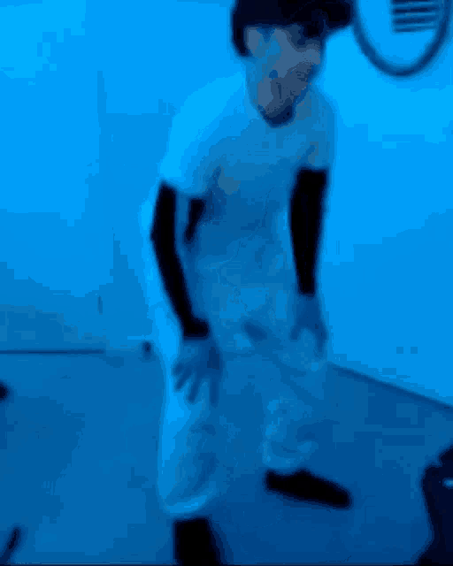 a blurry picture of a person in a white shirt
