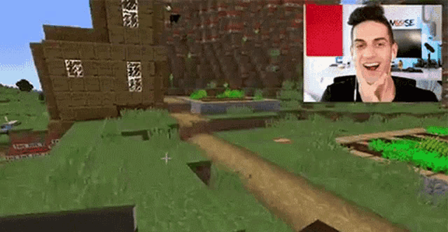 a man is playing a video game in front of a screen with a picture of him .