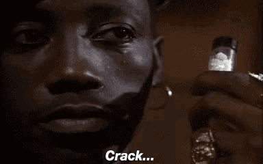 a man with a beard is holding a lighter and says `` crack '' .