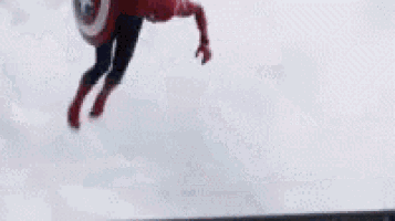 a man in a captain america costume is holding a shield .