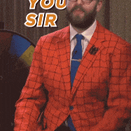a man in a suit and tie is pointing at the camera with the words thank you sir above him