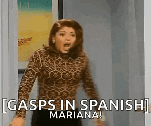 a woman is standing in a doorway with her mouth open and says gasps in spanish mariana !