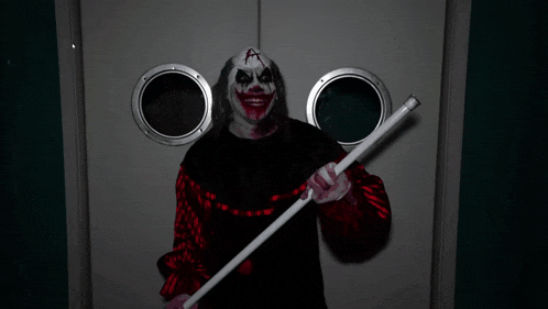 a scary clown is looking through a washing machine