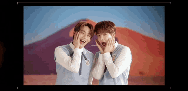 two young men are making funny faces in front of a camera