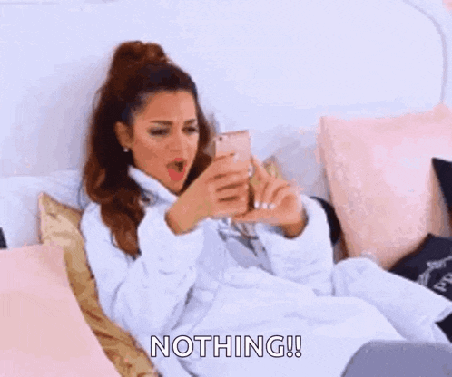 a woman in a bathrobe is laying on a bed and saying nothing !