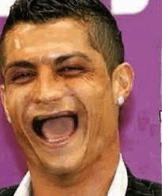 a man is making a funny face with his tongue out .