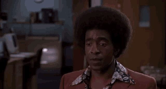 a man with an afro is smiling and saying uh no dat 's da butt