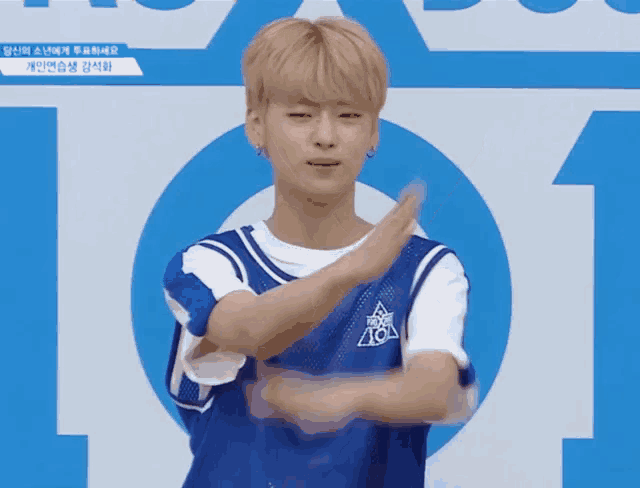 a young man wearing a blue shirt that says ' ao ' on it