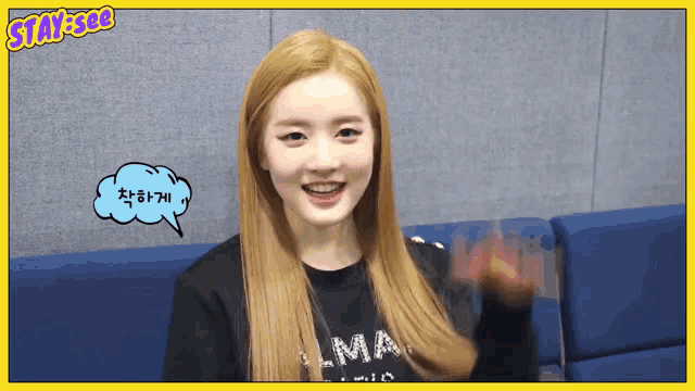 a girl with blonde hair wearing a black shirt that says lma on it