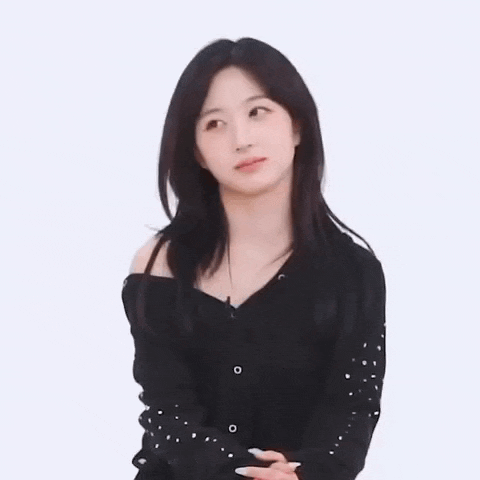 a young woman in a black off the shoulder top is looking at the camera .