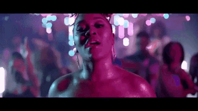 a woman is dancing in front of a crowd of people at a party .