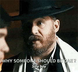 a man with a beard is wearing a hat and a scarf .