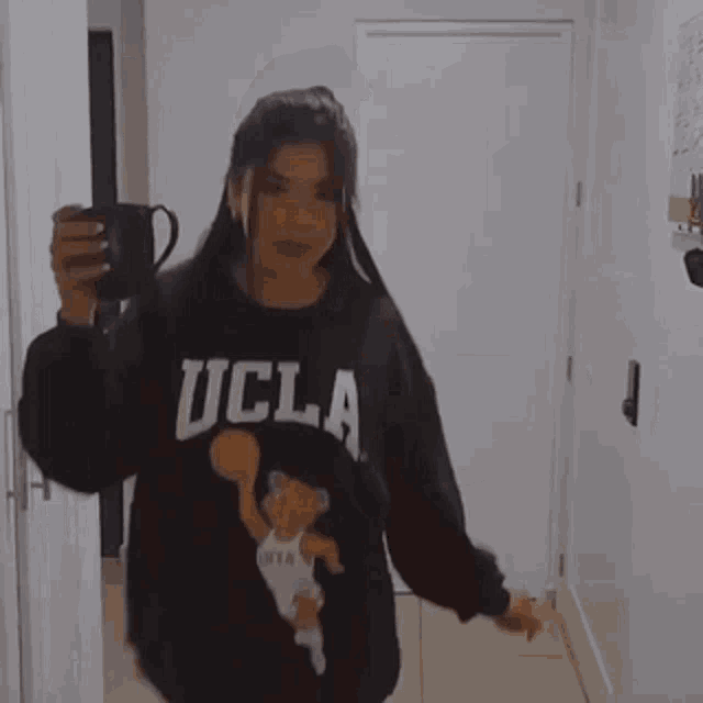 a blurry picture of a woman taking a selfie with her phone .