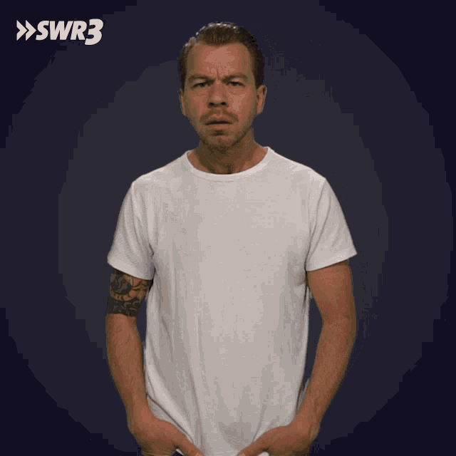 a man in a white t-shirt is standing in front of a blue background with swr3 written on it
