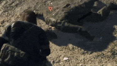 a soldier is laying on the ground in a video game while another soldier watches .