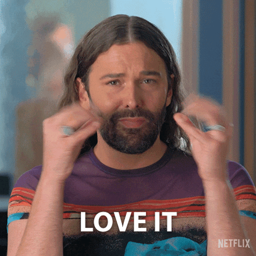 a man with long hair and a beard is wearing a shirt that says love it