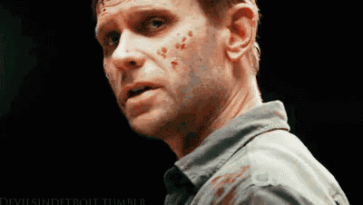 a close up of a man 's face with blood on his face .