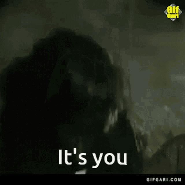 a man wearing sunglasses says it 's you while pointing at the camera