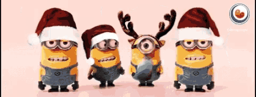 a group of minions wearing santa hats and reindeer horns
