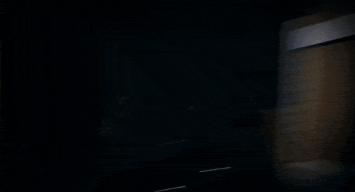 a blurred image of a person 's face with a dark background