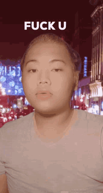 a man in a blue shirt with the words fuck u above him