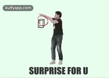 a man in a black shirt is holding a box with a red bow in his hand .