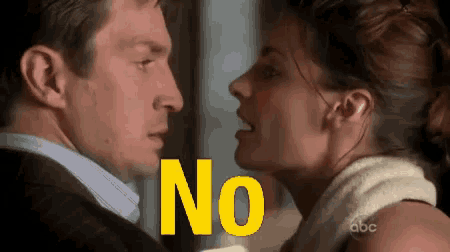 a man and a woman are looking at each other and the word no is on the screen behind them .