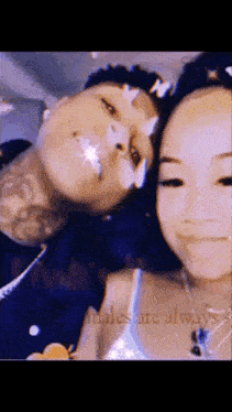 a man and a woman are standing next to each other and smiling for a picture .