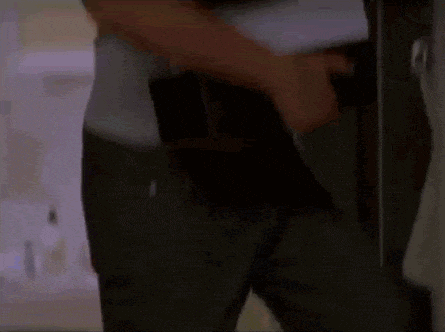a man in a grey shirt is carrying a stack of folders