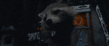 a blurred image of a person holding a gun with a light coming out of it