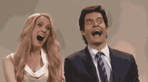 a man and a woman are sitting next to each other with their mouths open and making funny faces .
