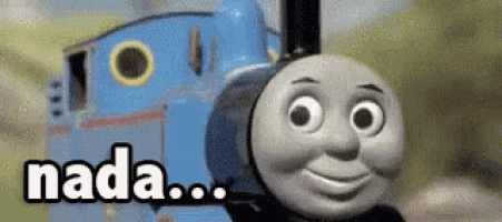 thomas the tank engine is smiling and looking at the camera while standing next to a train .