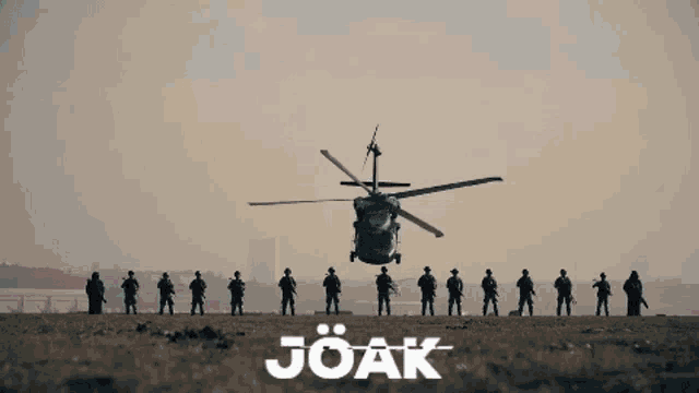 a group of soldiers standing in front of a helicopter that says joak on the bottom