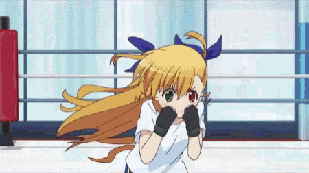 a girl with long blonde hair is wearing boxing gloves and a white shirt