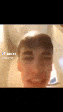 a close up of a man 's face with a tiktok watermark on it