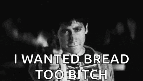 a black and white photo of a person holding a piece of bread with the words `` i wanted bread too bitch '' .