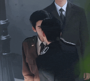 a man in a military uniform holds a gun to his face