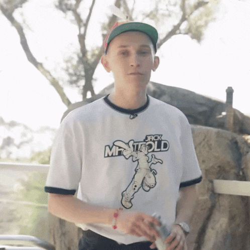 a young man wearing a white shirt that says " jack "