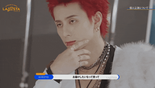 a man with red hair is talking to hiroto in a video for lagosta