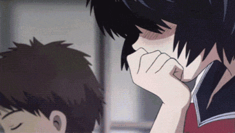 a boy and a girl are sitting next to each other and the girl is covering her mouth with her hand