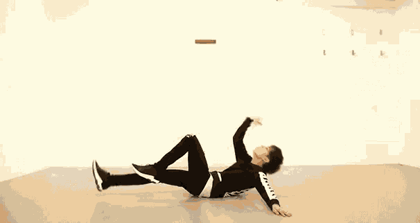 a man is laying on his stomach on the floor in a room .