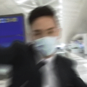 a blurry image of a man wearing a mask