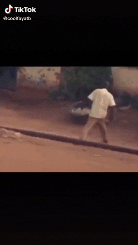 a man in a baseball cap is doing a trick in a tiktok video .