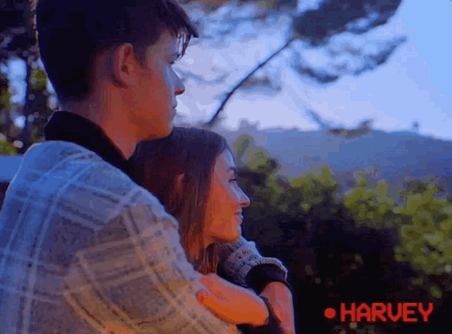 a man and a woman are hugging each other and the word harvey is on the bottom