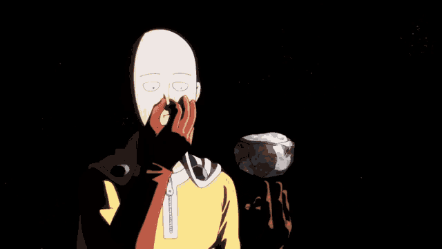 a bald man is covering his mouth with his hands while a rock is flying in the background